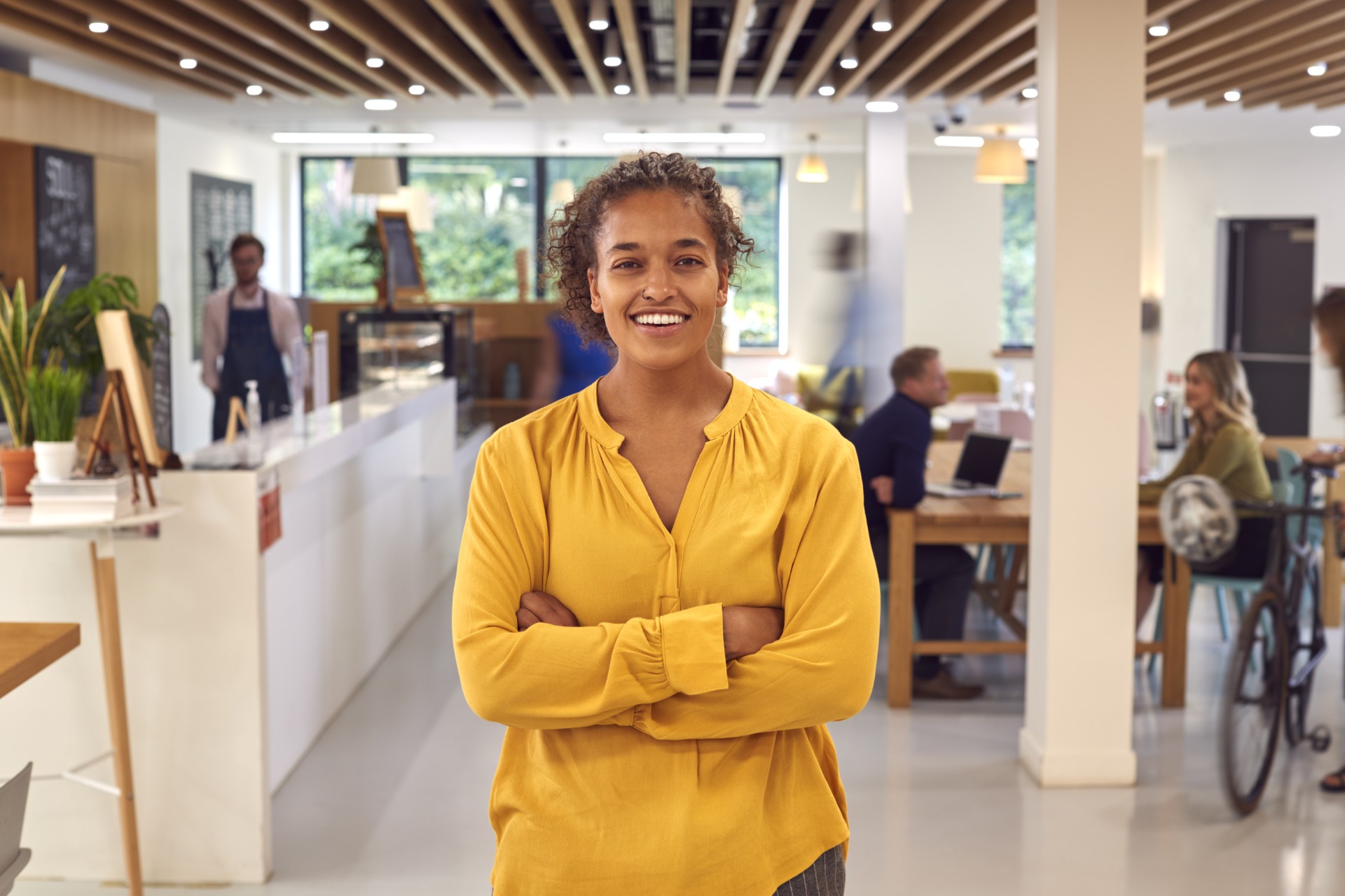 portrait-of-businesswoman-standing-in-busy-office-2026-01-05-23-01-34-utc